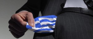 Symbolic photo: national bankruptcy of Greece, high taxes, Man in a suit with empty pockets in the national colours of Greece