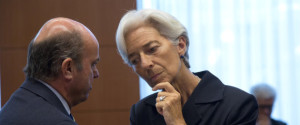 Managing Director of the International Monetary Fund Christine Lagarde, right, speaks with Spanish Economy Minister Luis de Guindos during a meeting of eurogroup finance ministers in Brussels on Saturday, June 27, 2015. Anxiety over Greece's future swelled on Saturday after Prime Minister Alexis Tsipras' call to have the people vote on a proposed bailout deal. (AP Photo/Virginia Mayo)