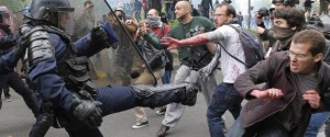 Riot police officers clash with protestors during a demonstration held as part of nationwide labor actions in Paris, France, Thursday, May 26, 2016. French protesters scuffled with police, dock workers set off smoke bombs and union activists disrupted fuel supplies and nuclear plants Thursday in the biggest challenge yet to President Francois Hollande's government as it tries to give employers more flexibility (AP Photo/Francois Mori)