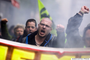 Labor union members on strike attend a demonstration against the French government and labor law reforms in Paris, Thursday, June 2, 2016. Workers are on strike at nearly all of France's nuclear plants and on the national rail service as part of months of protests over changes to labor protections. (AP Photo/Markus Schreiber)