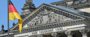 A German national flag is displayed in front of the main entrance of the Reichstag building, seat of the German lower house of parliament Bundestag, on June 7, 2016 in Berlin. / AFP / CHRISTOF STACHE        (Photo credit should read CHRISTOF STACHE/AFP/Getty Images)
