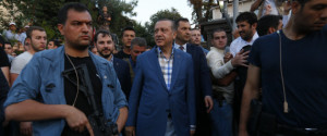 Turkish President Tayyip Erdogan walks through the crowd of supporters protected by bodyguards in Istanbul, Turkey, July 16, 2016. REUTERS/Murad Sezer