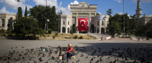 A woman waits for customers to sell food for pigeons outside the Istanbul University Tuesday, July 19, 2016. Turkey's state-run news agency says courts have ordered 85 generals and admirals jailed pending trial over their roles in a botched coup attempt. Dozens of others were still being questioned. (AP Photo/Emilio Morenatti)