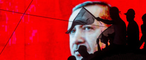 ANKARA, TURKEY - JULY 17: People wave Turkish flags in front of an electronic billboard displaying the face of President Recep Tayyip Erdogan at a rally on the streets of Kizilay Square in reaction to the failed military coup on July 17, 2016 in Ankara, Turkey. Clean up operations are continuing in the aftermath of Friday's failed military coup attempt which claimed the lives of more than 250 people. In raids across Turkey 6,000 people have been arrested in relation to the failed coup including high-ranking soldiers and judges, Turkey's Justice Minister Bekir Bozdag has said. (Photo by Chris McGrath/Getty Images)