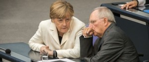 German Finance Minister Wolfgang Schaeuble (R) and German chancellor Angela Merkel attend a parliament session on the opening of a debate on next year's budget at the Bundestag (Lower House of German Parliament) in Berlin, on September 8, 2015. Finance Minister Wolfgang Schaeuble pledged to use Germany's financial firepower at hand to welcome a record influx of refugees, as hundreds more asylum-seekers arrived overnight at the key southern city of Munich. AFP PHOTO / DPA / MICHAEL KAPPELER GERMANY OUT (Photo credit should read MICHAEL KAPPELER/AFP/Getty Images)