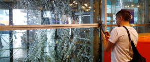 A man takes pictures of a broken window at Turkey's largest airport, Istanbul Ataturk, Turkey, following yesterday's blasts June 29, 2016. REUTERS/Osman Orsal
