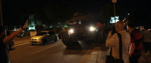 Tanks move into position as Turkish people attempt to stop them, in Ankara, Turkey, late Friday, July 15, 2016. Turkey's armed forces said it "fully seized control" of the country Friday and its president responded by calling on Turks to take to the streets in a show of support for the government. A loud explosion was heard in the capital, Ankara, fighter jets buzzed overhead, gunfire erupted outside military headquarters and vehicles blocked two major bridges in Istanbul. (AP Photo/Burhan Ozbilici)