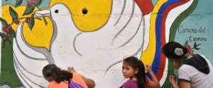 Women and a girl paint a mural alluding to peace on the road leading to Planadas, Tolima department, Colombia on August 26, 2016, where a peasant uprising in 1964 led to the birth of the Revolutionary Armed Forces of Colombia (FARC). The historic ceasefire between Colombia's government and the FARC rebel group will not end the government's commitment to fighting crime, the country's defense minister said Friday. / AFP / GUILLERMO LEGARIA (Photo credit should read GUILLERMO LEGARIA/AFP/Getty Images)