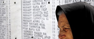 Survivor Loukia Gavrili, 86, sits by a plaque featuring the names of those killed by Nazi troops, on the day of the 71st anniversary of the Nazi wartime Distomo massacre, in the village of Distomo, in central Greece, June 10, 2015. On June 10, 1944, during the German occupation of Greece in World War Two, Waffen-SS troops of the 4th SS Polizei Panzergrenadier Division under the command of Fritz Lautenbach, burned the village of Distomo to the ground and killed 218 civilians, including women and children, in retaliation for an attack by partisans. Athens's demands for 278.7 billion Euros in reparations from Germany have gained momentum in recent years as Greeks suffer hardship during the economic crisis but while Berlin has repeatedly rejected the claims, some, including German President Joachim Gauck, have expressed their support Gavrili lost her sister and mother in the massacre. REUTERS/Yannis Behrakis TPX IMAGES OF THE DAY