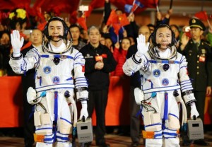 epa05588239 Chinese taikonauts Jin Haipeng (R) and Chen Dong wave during a farewell ceremony before embarking for the launch of the Shenzhou-11 spacecraft at the Jiuquan Satellite Launch Center in Jiuquan in Gansu province, China, 17 October 2016. China will launch the Shenzhou-11 spacecraft carrying two crew members into orbit to dock with the Tiangong-2 space lab on a 30-day mission on 17 October. EPA/HOW HWEE YOUNG