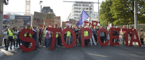 FILE - In this Tuesday, Sept. 20, 2016 file photo, protestors hold an Anti-CETA banner during a demonstration against international trade agreements in Brussels. The European Union's executive on Monday, Oct. 24, 2016 called for patience in an attempt to save a free trade deal with Canada and dismissed a Monday night deadline for a small Belgian region to provide its vital signature to the deal. (AP Photo/Virginia Mayo, FIle)