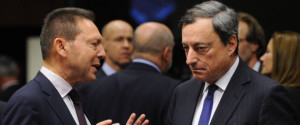 Greek Finance Minister Yannis Stournaras (L) speaks with European Central Bank (ECB) president Mario Draghi before a Eurogroup Council meeting at EU Headquarters in Brussels on December 17, 2013. AFP PHOTO/JOHN THYS        (Photo credit should read JOHN THYS/AFP/Getty Images)