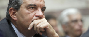 Conservative former prime minister Costas Karamanlis listens the speech of conservative opposition leader Antonis Samaras to conservative members of parliament in Athens, on Wednesday, Nov. 2, 2011. Samaras rejected Prime Minister George Papandreou's controversial bid to hold a referendum on Greece's new international bailout deal, and insisted that the Socialist government should resign and call early elections, halfway through its four-year mandate.(AP Photo/Petros Giannakouris)