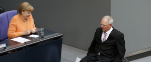 German Finance Minister Wolfgang Schaueble (R) passes Chancellor Angela Merkel after addressing the Bundestag, the lower house of parliament in Berlin September 11, 2012. Schaeuble said on Tuesday that the only way to solve the euro zone crisis was for the bloc's member states to correct the policy mistakes of the past. REUTERS/Fabrizio Bensch (GERMANY - Tags: POLITICS BUSINESS)