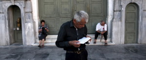 A pensioner waits to receive part of his pension at a National Bank branch in Athens, Greece July 13, 2015. Euro zone leaders clinched a deal with Greece on Monday to negotiate a third bailout to keep the near-bankrupt country in the euro zone after a whole night of haggling at an emergency summit. REUTERS/Yiannis Kourtoglou TPX IMAGES OF THE DAY
