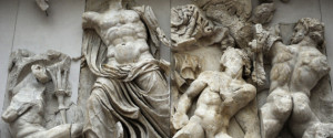 Pergamon Altar. Built by order of Eumenes II Soter. 164-156 BC by artists of the school of Pergamon. Marble and limestone. East frieze. Gigantomachy. Zeus fights by hurling lightning bolts, rain and massed clouds not only against two young Giants but also against their leader, Porphyrion (right). Pergamon Museum. Berlin. Germany. (Photo by: PHAS/UIG via Getty Images)