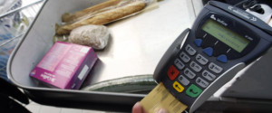 A shopper pays with his credit card in a supermarket in Nice southern France, February 25, 2008. Food prices are soaring, a wealthier Asia is demanding better food and farmers can