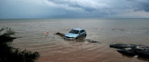 TOPSHOT - A car washed away into the sea is pictured following floods caused by heavy overnight rain, on 7 September, 2016 in Agia Triada, a suburb of Thessaloniki. / AFP PHOTO / Sakis Mitrolidis (Photo credit should read SAKIS MITROLIDIS/AFP/Getty Images)