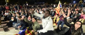People sit on Plaza Catalunya square in Barcelona waiting for polls results after the closing of polling stations on October 1, 2017. Spanish riot police stormed voting stations today as they moved to stop Catalonia's independence referendum after it was banned by the central government in Madrid. At least 92 people were confirmed injured as hundreds tried to prevent the polling stations from being closed, Catalan officials said. A total of 465 people were treated at hospitals and health centres, while Spain's interior ministry said 12 police officers were injured.  / AFP PHOTO / JOSE JORDAN        (Photo credit should read JOSE JORDAN/AFP/Getty Images)